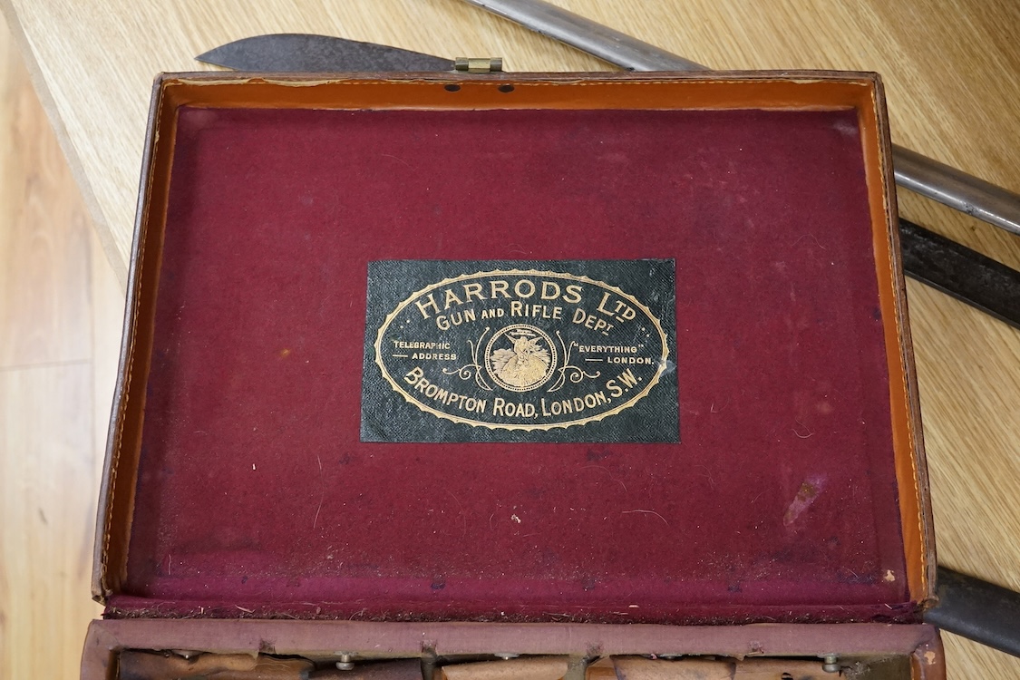 A Harrods brown leather gun/ammunition case, the lid with five leather restraining straps inside, and a good Harrods Ltd. Gun and Rifle Dept. label to the inside of the lid, dimensions; 40cm wide, 29cm high, 12.5cm deep